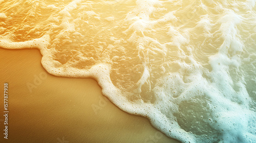 Abstract seafoam near sand in soft golden glow