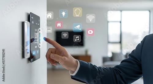 Man controls smart home technology via wall-mounted touchscreen interface, showcasing automated home features.