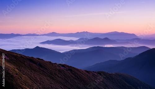 soft lavender mist over distant mountain range at dawn