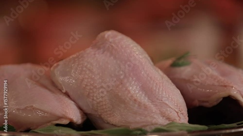 Raw chicken breasts on silver platter, with fresh sage. Perfect for food preparation, gourmet cooking, and healthy recipe videos. High-quality poultry ingredients ready for the kitchen.