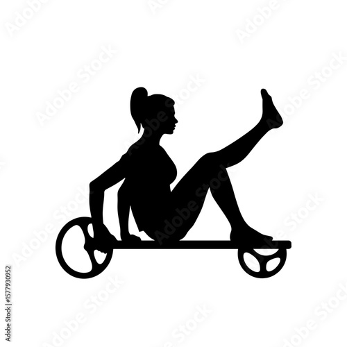 Woman exercising on wheeled platform in silhouette  