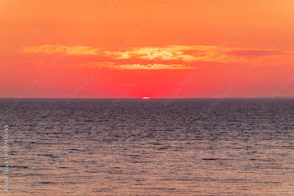 Obraz premium Beautiful red and orange sunrise over the sea.