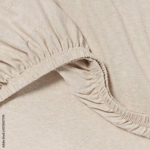 Soft beige fabric with gathered elastic edge for comfortable clothing design and fashion applications.