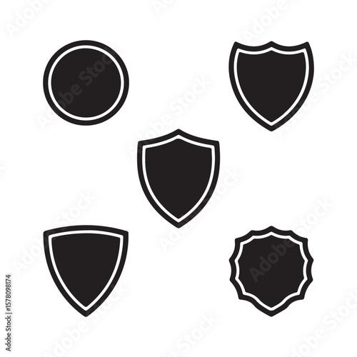 Collection of five distinct shield silhouettes isolated on white background