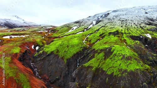 This stunning moss Lush Green Valley is framed by breathtaking SnowCapped Mountains, creating beauty in Iceland
