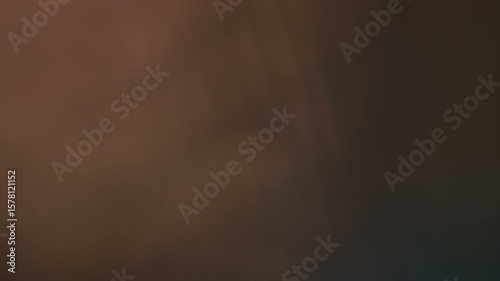 Abstract cinematic light leak overlay with subtle lens flare effects on dark background, creating organic film burn and bokeh for video editing