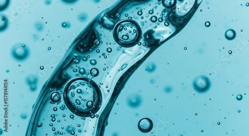Close-up view of a flowing, translucent liquid with numerous air bubbles.