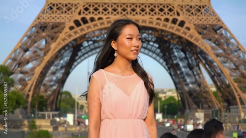 Woman in pink dress near Eiffel Tower