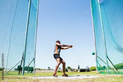 Man playing hammer throw against sky on sunny day