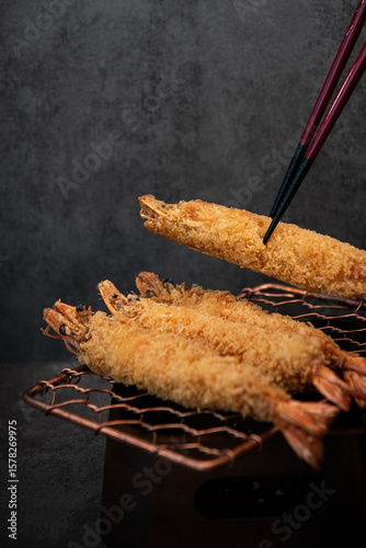 Golden Tempura Shrimp on a Wire Rack with Chopsticks