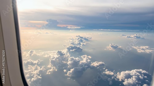 Cloudscape from Above: A stunning view of cumulus and stratus clouds fills the frame, the sunlight bathing the landscape in a soft, ethereal glow, evoking a sense of peace and limitless expanse.