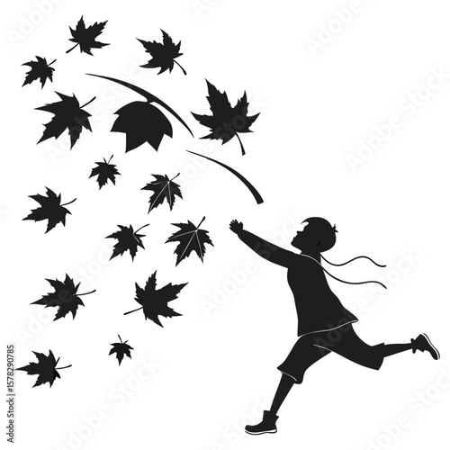 Boy reaching for falling autumn leaves child