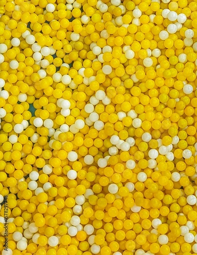 Abstract background of yellow and white small round balls creating a textured surface