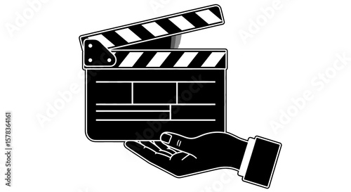 Hand holds clapperboard for filmmaking and production. Movie set, director, production, entertainment