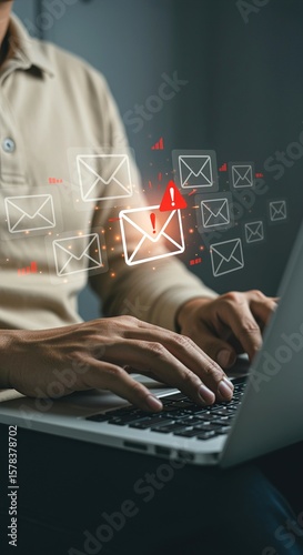 Person typing on a laptop with email icons and a red warning symbol floating above the keyboard area