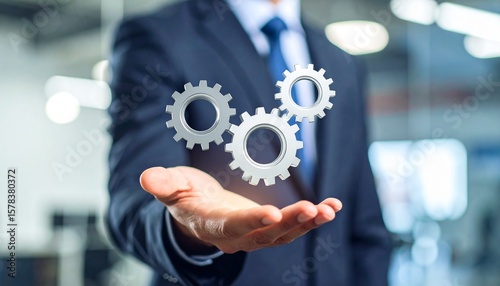 Scene with a blurred man in a suit holding three spinning gears in the palm of his hand