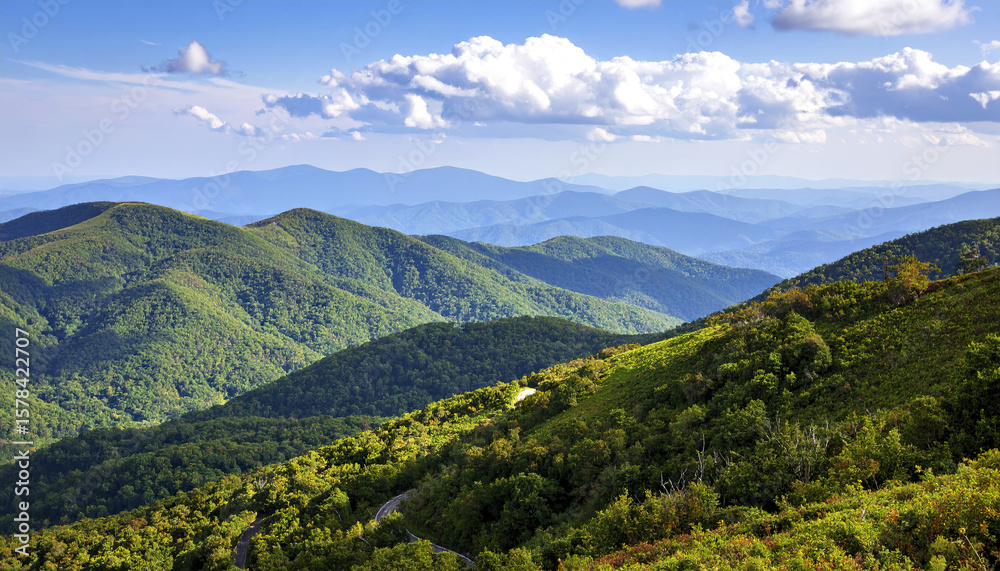 Obraz premium Green mountain landscape with blue ridge and appalachian mountain views under cloudy sky
