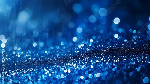 Blue glitter sparkles creating festive bokeh background for celebration