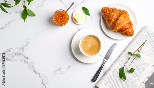 Parisian breakfast flat lay with a fresh croissant, café au lait, and jam on a classic white marble bistro table.
