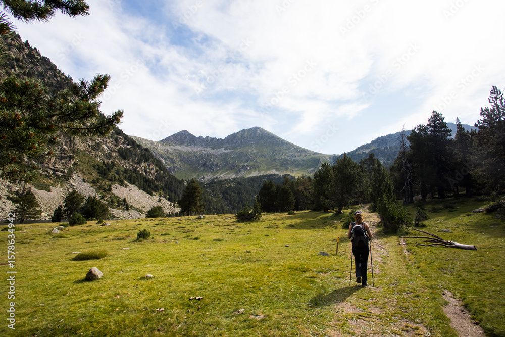 Obraz premium Young hiker woman in Vall de Boi, Aiguestortes and Sant Maurici National Park, Spain