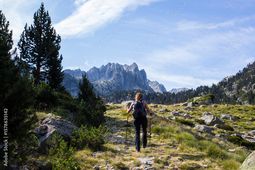 Fototapeta premium Young hiker woman in Vall de Boi, Aiguestortes and Sant Maurici National Park, Spain