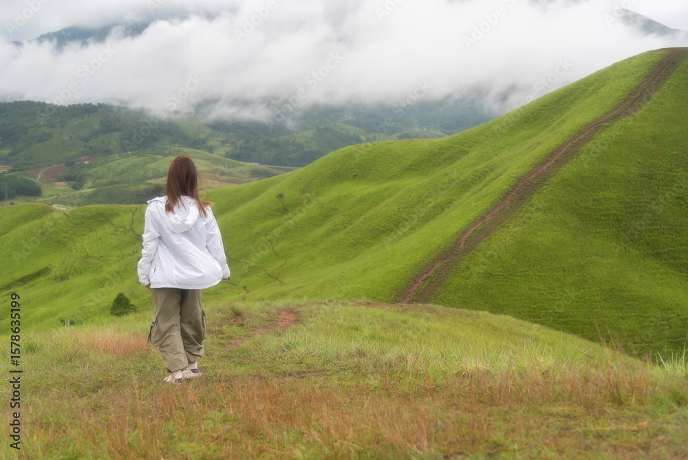 Lifestyle traveler women raise hand feeling good relax and happy freedom in the sunrise morning. Travel and summer Concept Lifestyle traveler women raise hand feeling good relax and happy freedom in the sunrise morning. Travel and summer Concept