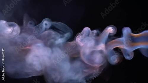 Abstract smoke art with vibrant colors flowing and swirling against a black background