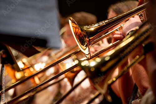 Canvas-taulu Close-up view of high school band students performing with brass instruments, including trumpets and trombones, during a school concert