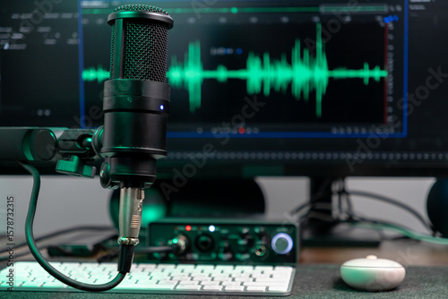 Konstfotografi Black studio microphone with glowing green audio wave visualizer on computer mon