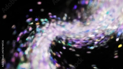 Swirling Abstract Glitter Particles in a Tornado Shape Against a Black Background