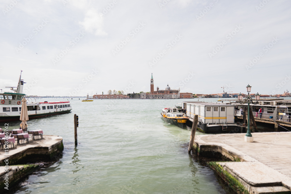 Fototapeta premium Exploring Venice's peaceful waters with boats by historic sites