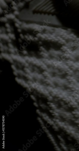 white sneaker rests on black sand, partially obscured by swirling smoke, creating a dramatic and moody atmosphere, inviting curiosity and exploration