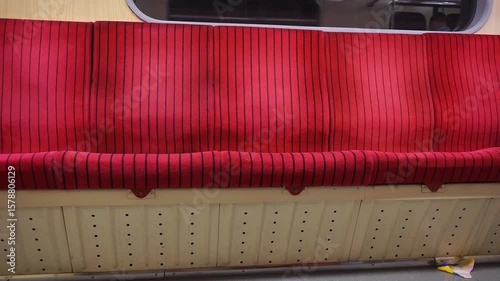 A closed-angle view of worn, vintage metro seats from the old Soviet era, showcasing the style and wear of the time.
