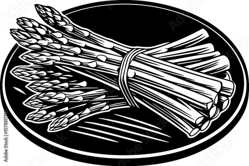 A bundle of asparagus spears on a black plate
