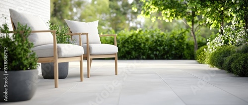 Relaxing outdoor patio scene with chairs and lush greenery