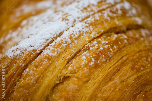 closeup of icing sugar sprinkled on croissants