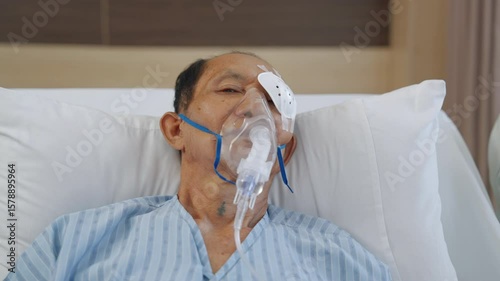 Close up of patient's face using oxygen mask in hospital, healthcare concept