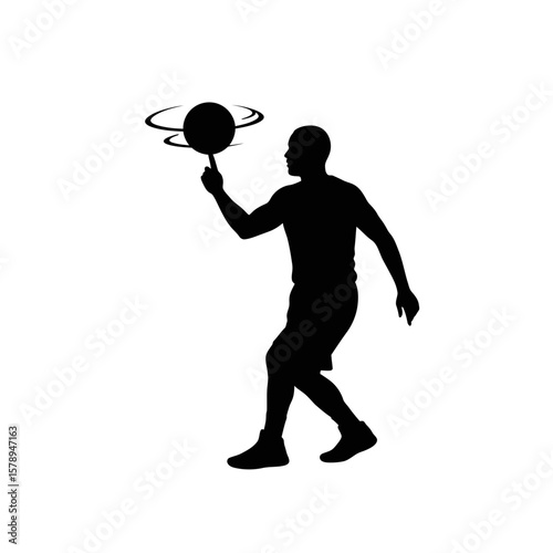 Mastery Silhouette: A basketball player expertly balances a basketball on one finger, showcasing skill and control in this striking silhouette image.