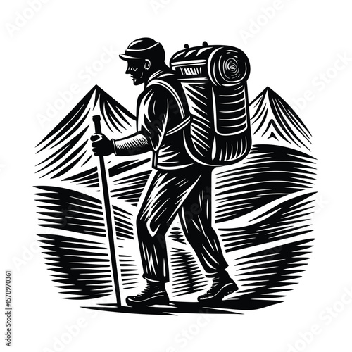 Hiker with backpack and walking stick in mountains