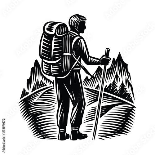 Hiker with backpack and walking stick in mountains