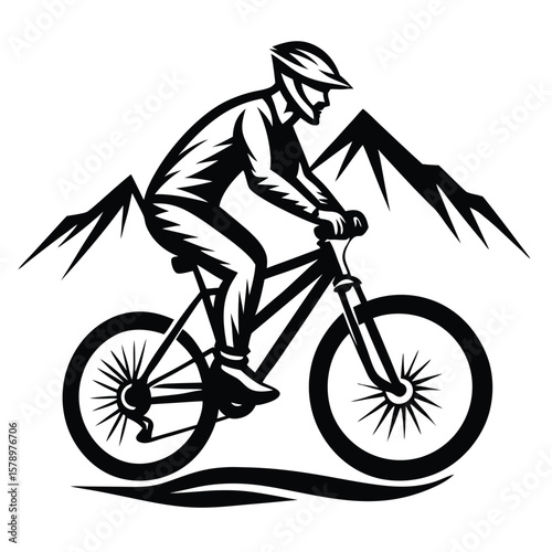 Mountain biker silhouette against sharp peaks mountain biking