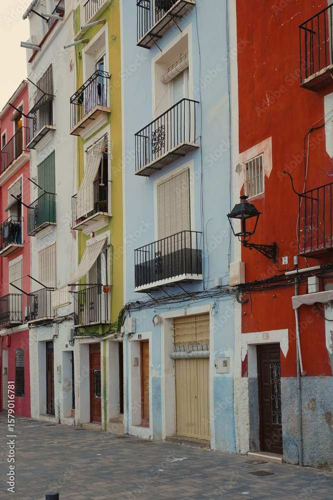 Fototapeta premium Colorful facades of traditional Mediterranean houses in Villajoyosa, Alicante, Spain, reflecting the town's maritime heritage and vibrant coastal charm