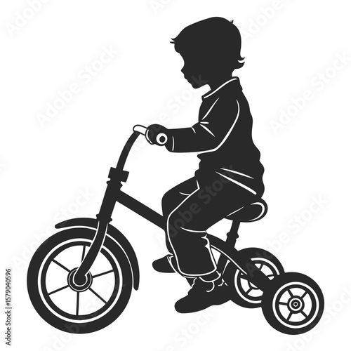 Silhouette of a young boy riding a tricycle enjoying outdoor activity and learning to pedal on a sunny day