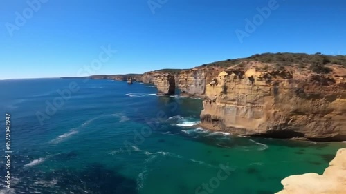 Wallpaper Mural Aerial views of the rugged cliffs and turquoise waters of Loch Ard Gorge beneath clear skies, highlighting the area's natural beauty and striking coastal scenery Torontodigital.ca