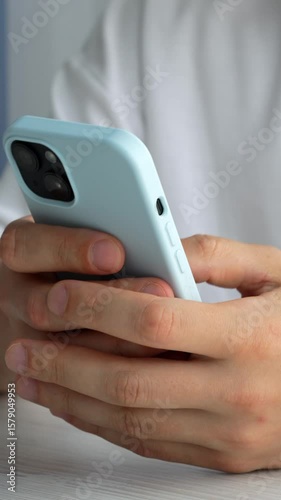 close-up of a mobile phone in a blue case in the hands of a guy.
A man scrolls with his finger on the screen of a mobile phone.
Phone, mobile, screen, device