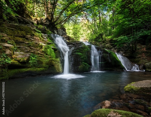 kazancheto waterfall in strandzha nature park bulgaria twin streams cascade over mossy rocks into a dark pool surrounded by lush green forest peaceful hidden natural gem in summer
