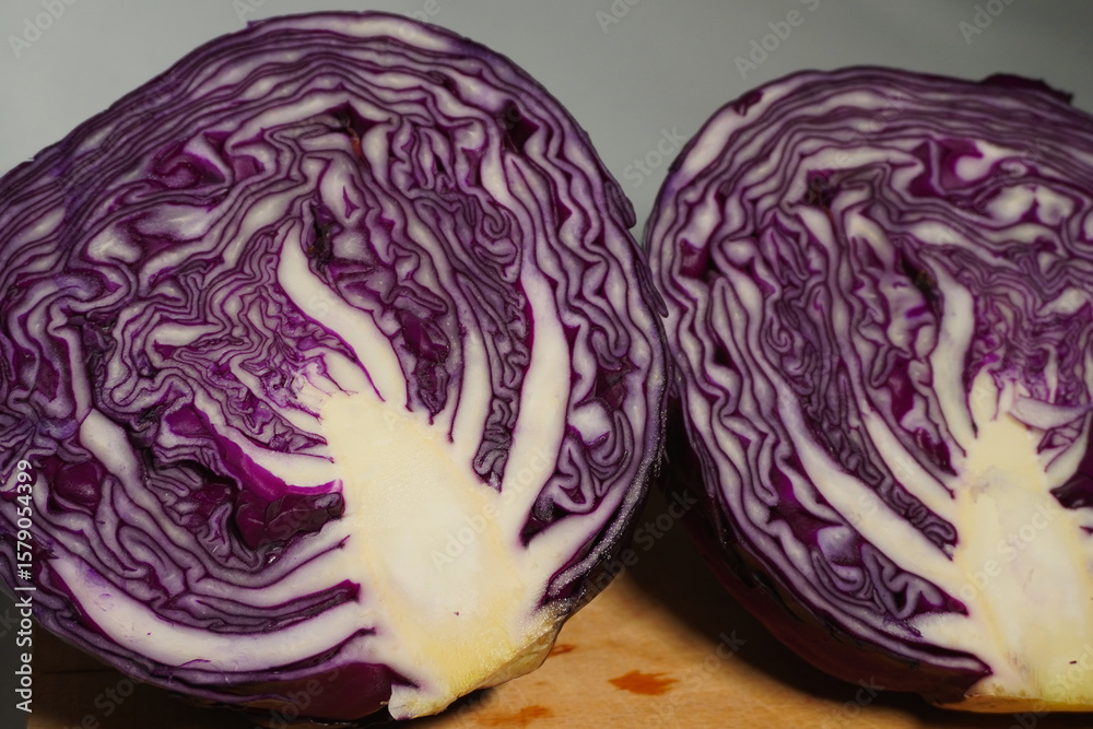 Fototapeta premium Purple layers unfurl in vegetal geometry: each concentric fold of the sliced purple cabbage reveals natural fractals, hidden symmetry, and living architecture within its vibrant, crystalline core.