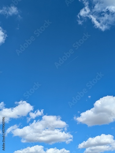 Fototapeta Naklejka Na Ścianę i Meble -  Blue sky with strong big white fluffy clouds