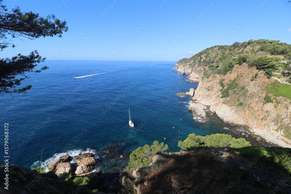 Obraz premium Rocks, stones and cliffs of the Codolar cove of Tossa de Mar in the south of the Costa Brava in summer