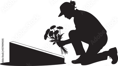 Person placing flowers at memorial silhouette black